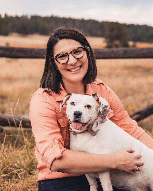 President & CEO, Kelley Likes, holding her dog, May